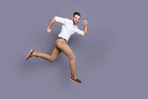 Full length body size view of his he nice attractive content cheerful cheery man jumping distance marathon motivation ambition career isolated over grey violet purple pastel color background — стоковое фото