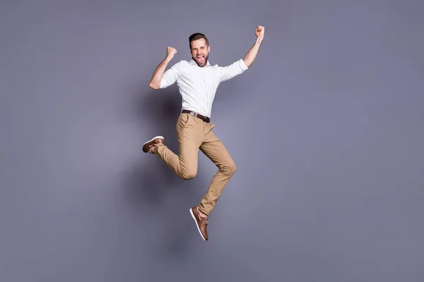 Full length body size view of his he nice attractive glad ecstatic brunet guy top sales manager employee it expert leader jumping celebrating having fun isolated over gray pastel color background — ストック写真