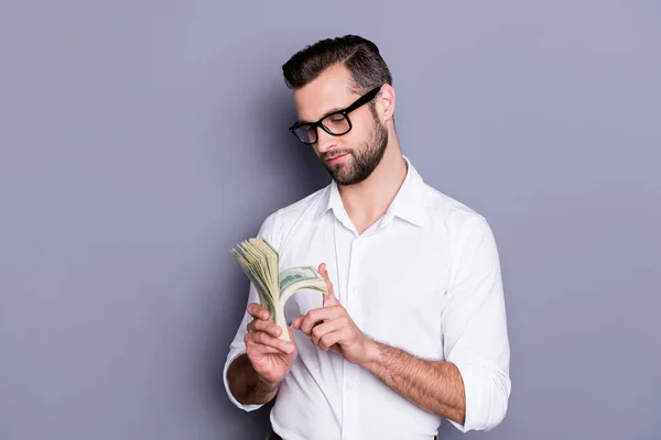 Portrait of his he nice attractive rich wealthy successful brunet guy banker financier holding in hands large bis sum money counting isolated over gray purple violet pastel color background — Stock Photo, Image