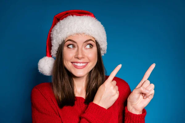 Close up photo positive girl in santa claus hat point index finger copyspace direct way x-mas christmas newyear ads promotion wear style stylish sweater isolated dark blue color background — Stock fotografie