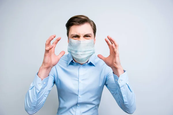 Close-up portrait of annoyed fury guy wearing safety gauze mask mers cov risk panic syndrome isolated on gray color background — Stock Photo, Image