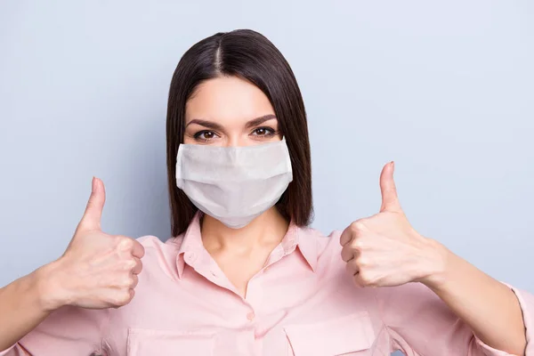 Close-up portrait of pretty content girl wearing safety mask showing double thumbup therapy mers cov isolated on gray color background — Stock Photo, Image
