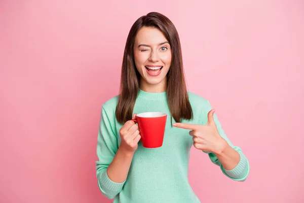 Retrato de otimista muito morena cabelo reto menina piscar promover chá desgaste suéter isolado no fundo cor-de-rosa — Fotografia de Stock