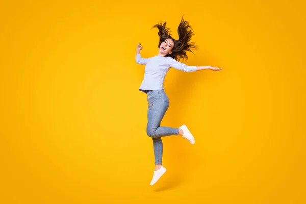 Full length body size view of her she attractive pretty thin cheerful cheery girl jumping throwing hair having fun good mood walking isolated bright vivid shine vibrant yellow color background — Stock Photo, Image