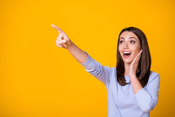 Photo of astonished positive girl see incredible ads promo impressed touch hands face scream point index finger copyspace wear good look clothes isolated over vivid color background — Stock Photo, Image