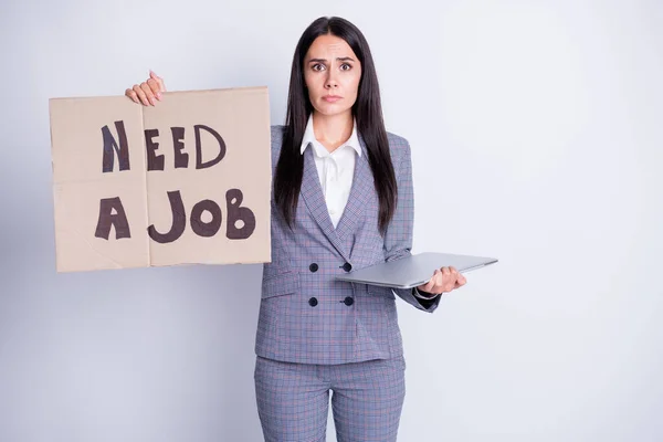 Photo of attractive fired sad terrified lady hold carton placard seek freelance job offer work proposition need money hold netbook formalwear plaid suit isolated grey color background — Stock Photo, Image