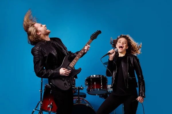 Crazy funky two people popular artist man play bass guitar woman sing song mic composition enjoy rhythm event punk tour festival isolated over bright shine color background
