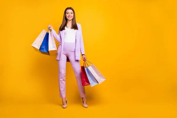 Full length photo of pretty business lady hold many packs having rest visit favorite shop after working day wear purple office suit isolated yellow color background — Stock Photo, Image