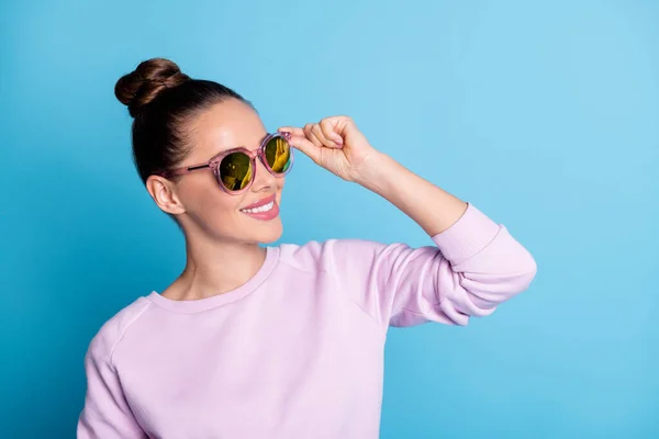 ( 영어 ) Profile side photo of content friendly attractive girl enjoys holiday look copyspace touch eyeglasses wear pullover outlocated over blue color background — 스톡 사진