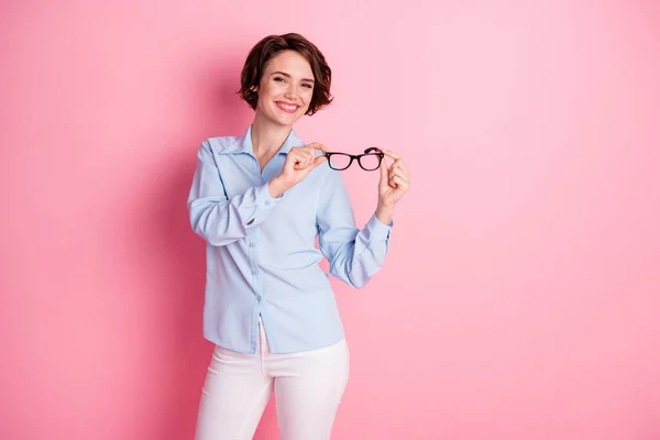 Retrato de ella ella agradable atractiva encantadora intelectual alegre alegre morena chica sosteniendo en las manos especificaciones buena visión saludable aislado rosa pastel color fondo —  Fotos de Stock