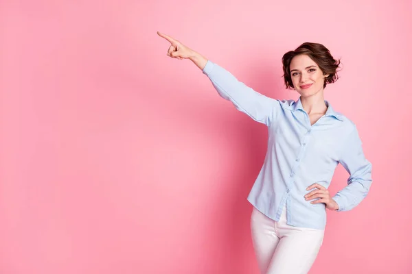 Photo of attractive confident business lady direct finger up side empty space show sale discount shopping banner wear blue office shirt white pants isolated pink pastel color background — Zdjęcie stockowe