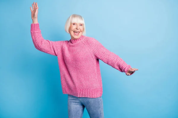 Photo portrait of elderly woman dancing isolated on pastel blue colored background — Stock Photo, Image