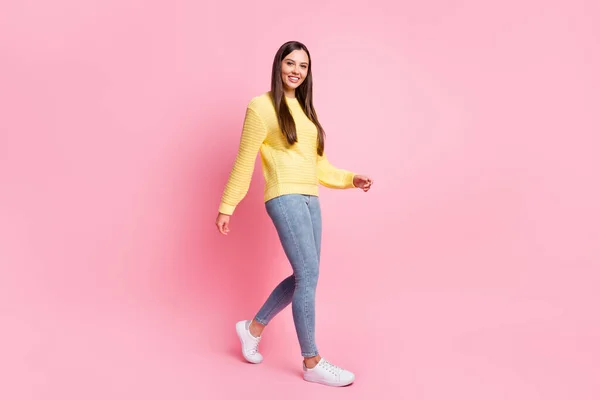 Full size profile side photo of young beautiful attractive smiling positive girl go walk take step isolated on pink color background — Stock Photo, Image