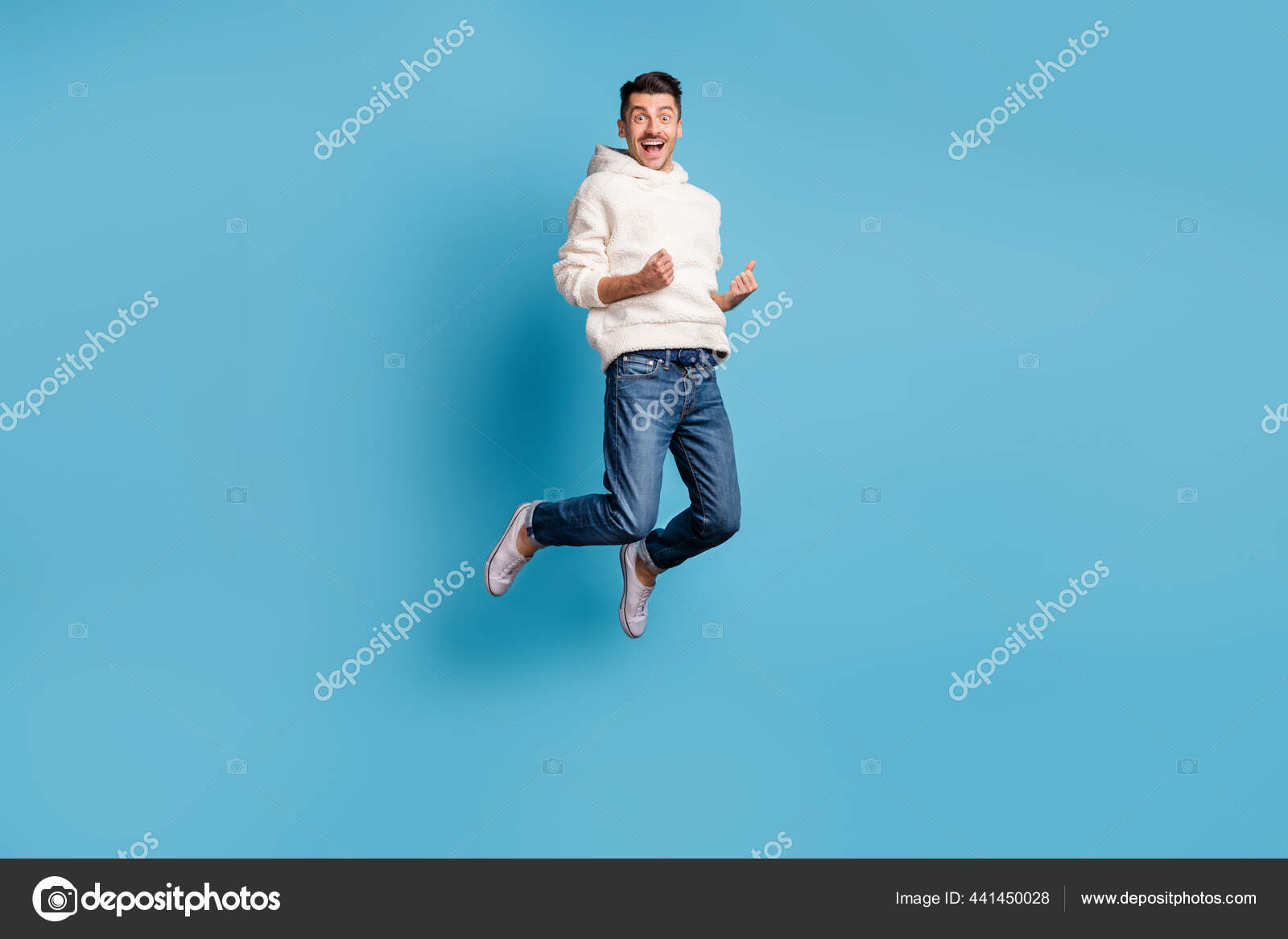 Photo portrait full body view of funny celebrating man jumping up wearing  woolen hoodie isolated on pastel blue colored background Stock Photo by  ©deagreez1 441450028