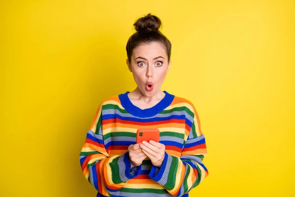 Zdjęcie pod wrażeniem słodkie brunetka dziewczyna trzymać telefon nosić tęczowy sweter izolowany na jasnożółtym tle kolor — Zdjęcie stockowe