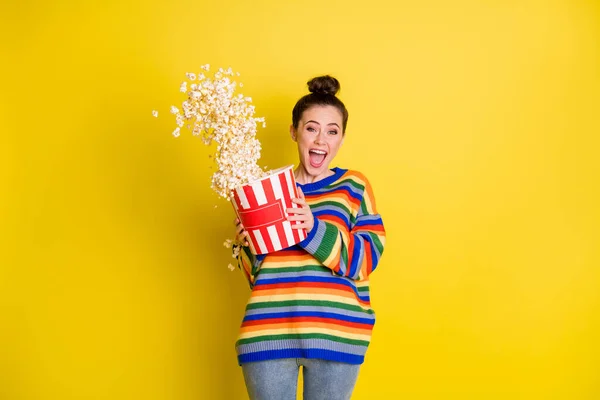 Photo of crazy rejoicing ecstatic hipster girl enjoying jokes from tv eating snack isolated over bright color yellow background — Stock Photo, Image