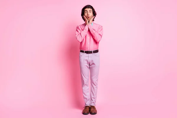 Full size photo of shocked charming young man hold hands cheekbones unexpected present isolated on pink color background — Stock Photo, Image