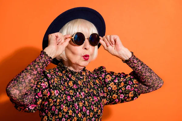 Портрет шокирован удивлен удивлен крутой бабушке смотреть копия пространства касания солнцезащитные очки изолированы на оранжевом фоне цвета — стоковое фото