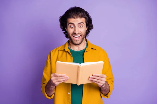 Photo of young attractive man hold book notebook read amazed excited happy smile isolated over purple color background