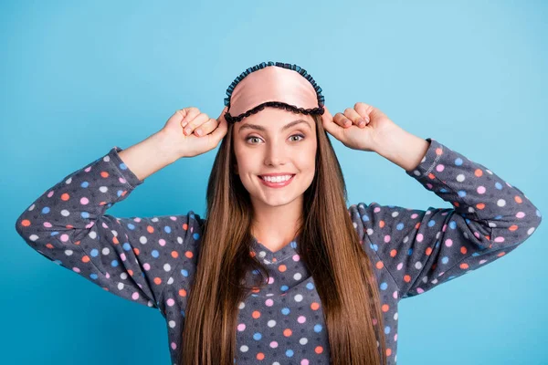 Closeup portrait photo of pretty lovely young girl shiny smiling hands head change clothes after sleep prepare work wear mask dotted shirt pajamas sleepwear isolated blue color background — Stock Photo, Image