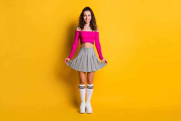 Full length photo of cute sweet amazing wavy lady wear pink off shoulders top naked belly short checkered skirt white long socks footwear isolated yellow color background — Stock Photo, Image