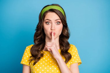 Photo of astonished girl put index finger on mouth dont tell secret concept isolated over blue color background clipart