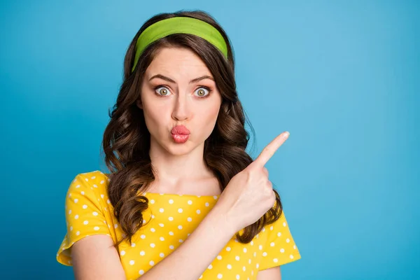 Photo portrait of pouting woman pointing finger at blank space isolated on pastel light blue colored background — Stock Photo, Image