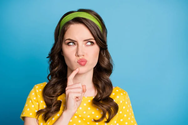 Photo of minded girl touch finger with chin look copyspace think isolated over blue color background — Stock Photo, Image