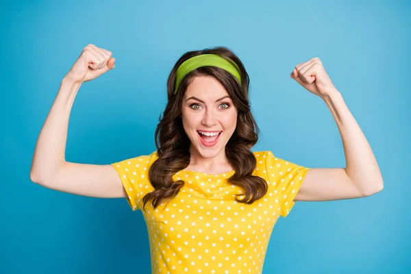 Portrait of good mood energetic girl show her biceps hands isolated over blue color background — Stok Foto