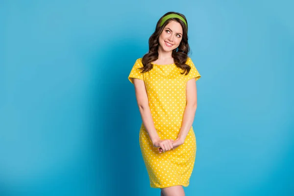 Foto de positivo atraente menina bonita olhar espaço vazio desgaste amarelo saia verde isolado sobre azul cor de fundo — Fotografia de Stock