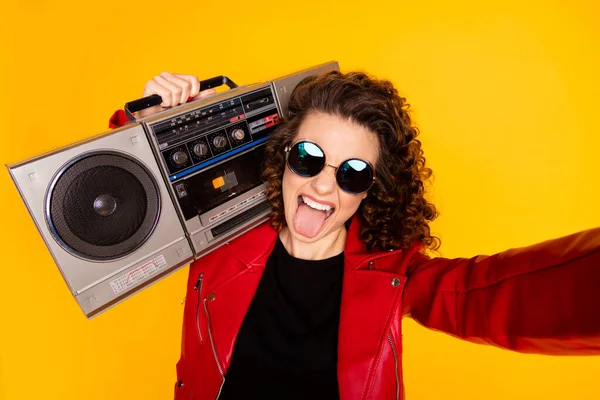 Self-portrait of naughty comic glad crazy wavy-haired girl carrying player grimacing isolated bright yellow color background — Stock Photo, Image