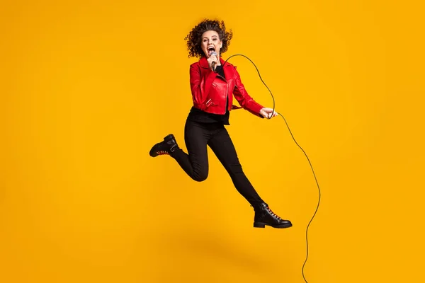 Full length body size view of pretty cheerful glad wavy-haired girl jumping singing hit hobby free time isolated on bright yellow color background — Stock Photo, Image