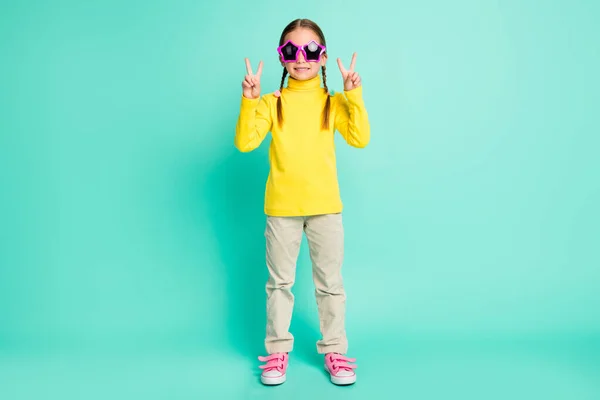 Full size of pretty girl make two v-sing wear yellow turtleneck white pants star sunglass isolated on shine teal color background — Fotografia de Stock