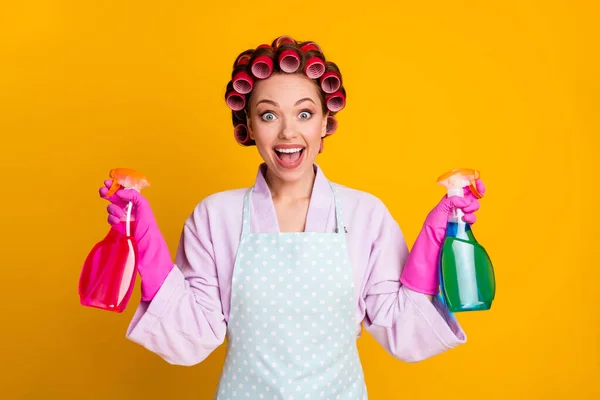 Photo of surprised girl hold chemical spray bottles wear bath robe gloves apron isolated shine color background