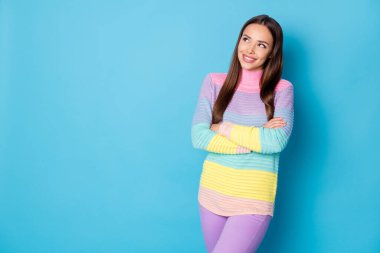 Portrait of lovely dreamy brown-haired cheerful girl folded arms creating new solution copy space isolated over bright blue color background clipart