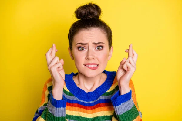Close up retrato de estressado orando morena menina dedos cruzados usar camisola arco-íris isolado no fundo de cor amarelo brilhante — Fotografia de Stock