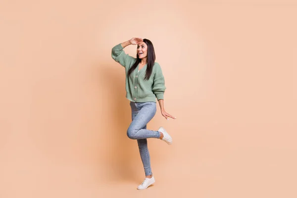 Full size photo of amazed happy young woman look far empty space hold hand forehead isolated ob beige color background — Stock Photo, Image