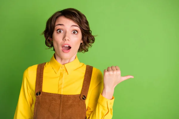Фото сумасшедшей шокированной девушки с открытым ртом прямой палец пустое пространство носить желтую рубашку в целом изолированный зеленый цвет фона — стоковое фото