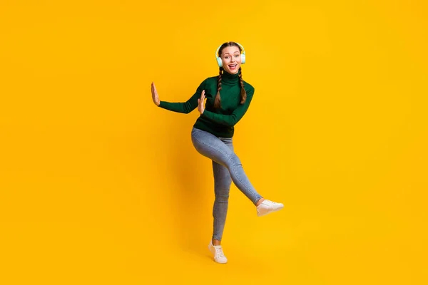 Full length body size view of lovely cheerful girl listening music having fun dancing isolated on bright yellow color background — Stock Photo, Image