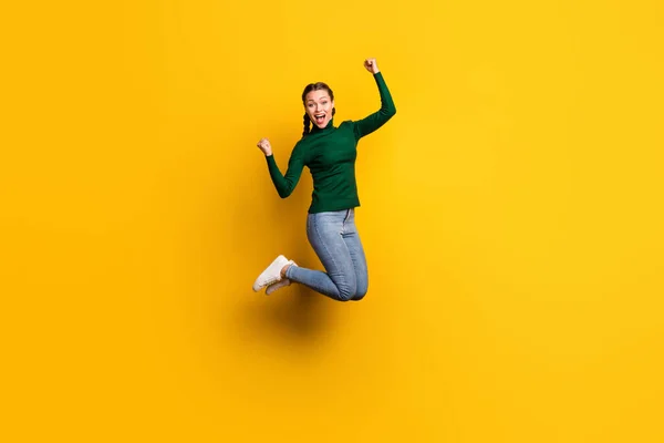フル長さボディサイズ写真笑顔女性ジャンプ高いジェスチャーのような勝者隔離上の明るい黄色の背景 — ストック写真