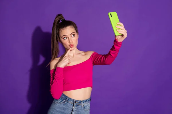 Foto de blogger girl hold cellphone hacer selfie dedo cara desgaste rosa superior aislado color púrpura fondo —  Fotos de Stock