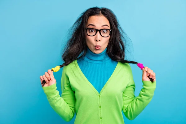 Photo of funky surprised lovely young woman hold pigtails fooling amazed face isolated on blue color background — Stock Photo, Image