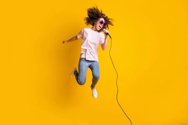 Fényképezés portré teljes test kilátás lány ugrás fel ének mikrofon elszigetelt élénk sárga színű háttér — Stock Fotó