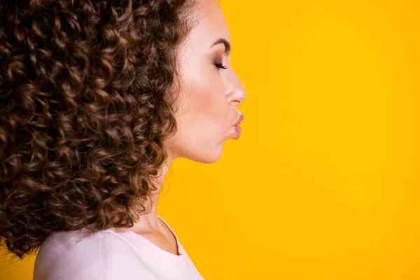 Photo portrait close-up cropped profile of woman sending air kiss isolated on vivid yellow colored background — Stock Photo, Image