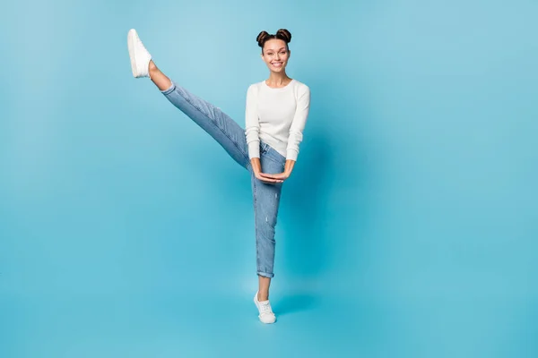 Full length photo of lady dance raise leg toothy smile wear white sweater jeans footwear isolated blue color background — Stock Photo, Image