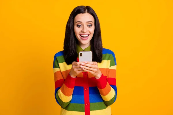 stock image Photo of surprised shocked young girl chat mobile cellphone news isolated over yellow color background