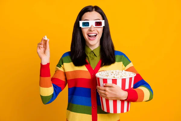 Photo of beautiful excited amazed brown hair girl eat popcorn watch 3d technology film isolated over yellow color background — Stock Photo, Image