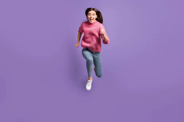 Full body portrait of astonished attractive person run jump open mouth isolated on violet color background