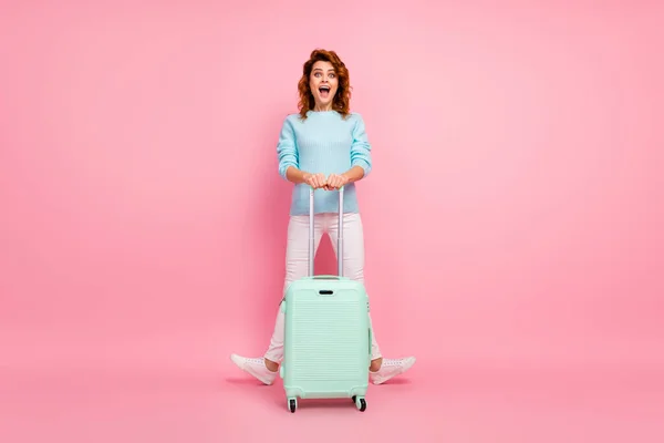 Full length body size view of her she nice-looking attractive lovely pretty glad cheerful wavy-haired girl carrying luggage having fun isolated over pink pastel color background — стоковое фото