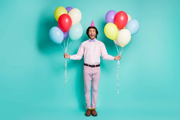 Ganzkörper-Foto von glücklich lächelnden Gentleman halten Luftballons gekleidet formale Outfit gelbe Socken isoliert auf türkisfarbenem Hintergrund — Stockfoto